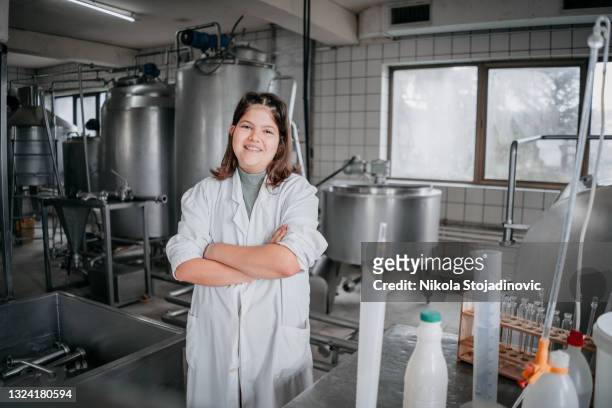 couple bottling milk on manufacture - voedselveiligheid stockfoto's en -beelden