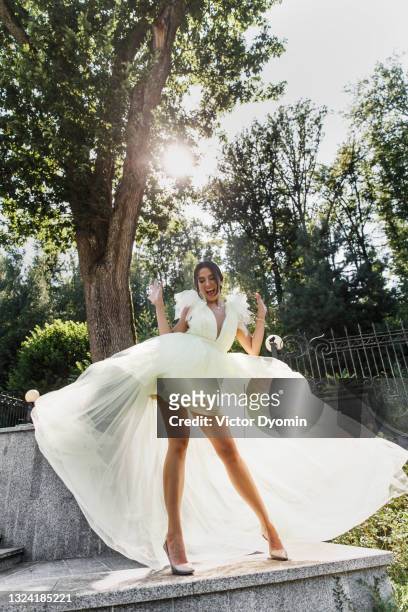 happy young bride in the bright sun - white wedding dress stock pictures, royalty-free photos & images