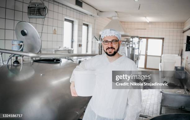 man at work in a dairy factory - dairy factory stock pictures, royalty-free photos & images