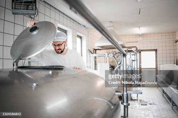 employee working in raw milk sector - dairy farming stockfoto's en -beelden