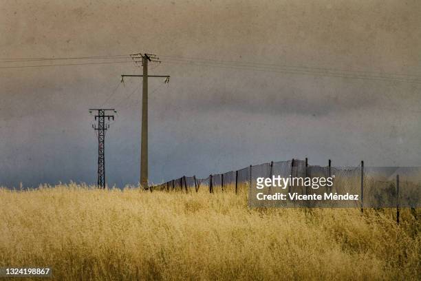 electric towers and fence - vellum stock pictures, royalty-free photos & images