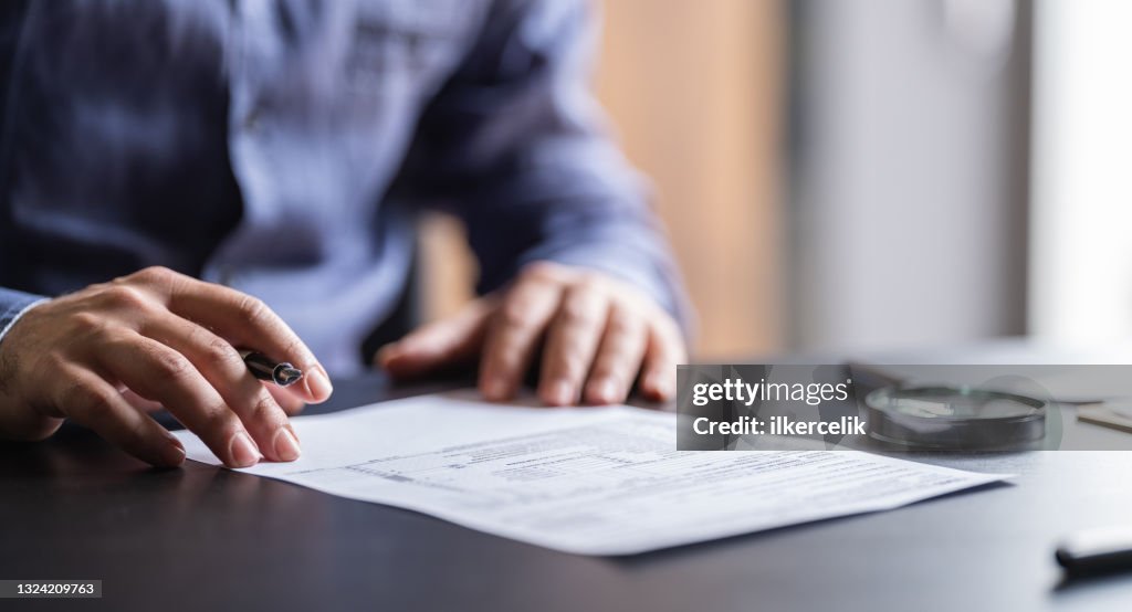 Man Filling In The Tax Form