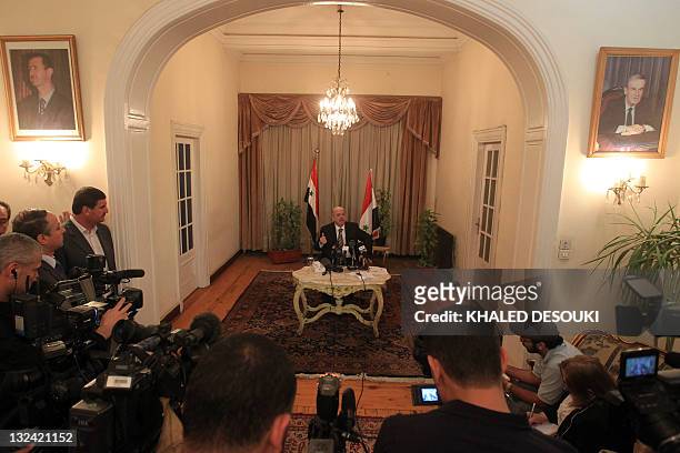 Pictures of Syrian late president Hafez al-Assad and his son president Bashar al-Assad are seen in the Syria’s embassy as Yussef al-Ahmad, Damascus'...