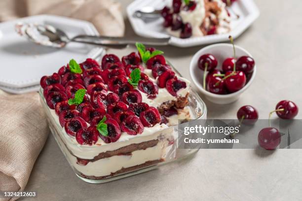 traditional italian dessert tiramisu with cherries and mascarpone - tiramisu stockfoto's en -beelden