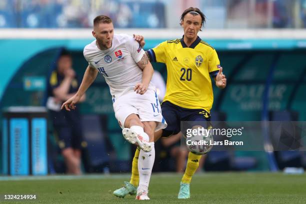 Milan Skriniar of Slovakia makes a pass whilst under pressure from Kristoffer Olsson of Sweden during the UEFA Euro 2020 Championship Group E match...