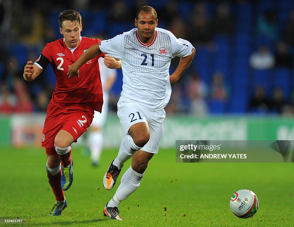 Wales' defender Chris Gunter (L) vies wi