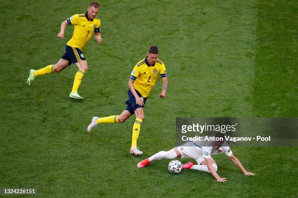 Robert Mak of Slovakia is closed down by Mikael Lustig and Sebastian Larsson of Sweden during the UEFA Euro 2020 Championship Group E match between...