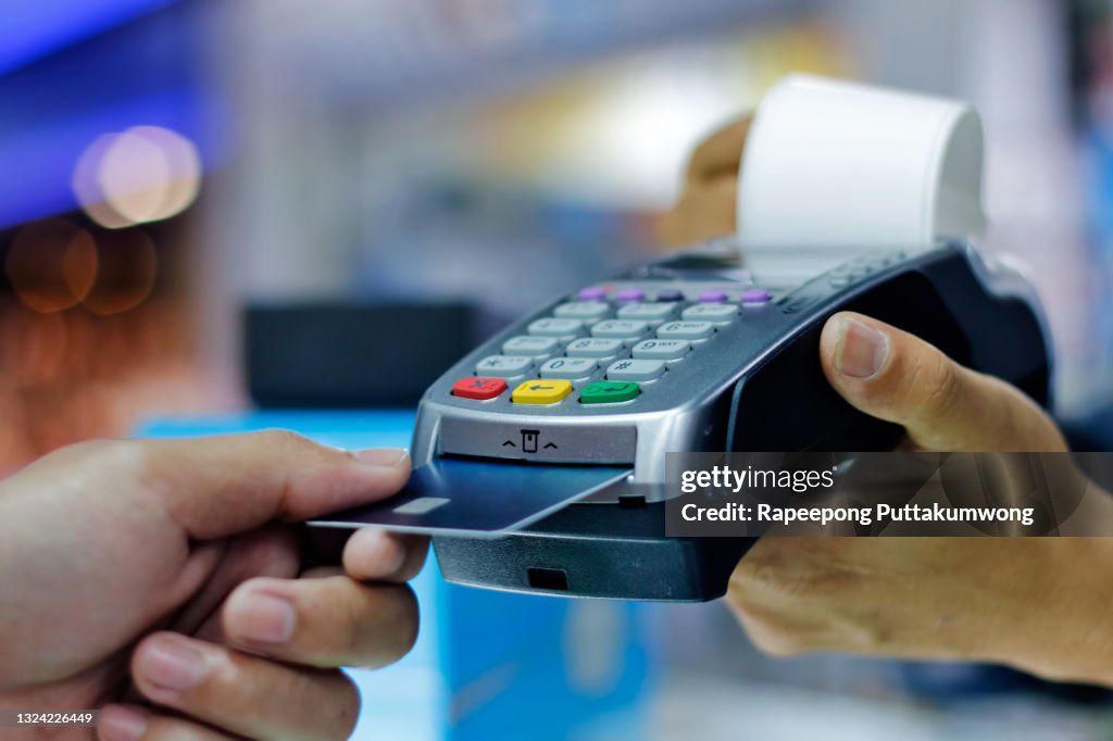 Man make payment with credit card swipe through terminal. customer paying with EDC machine. buy and sell product or service