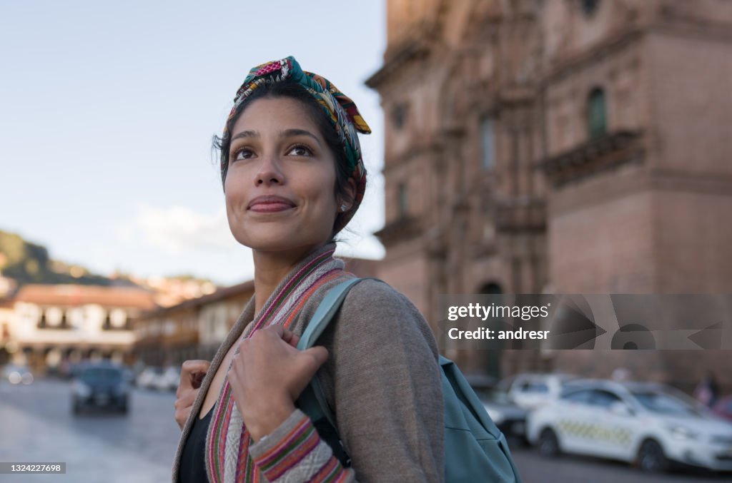 Happy woman sightseeing around Cusco around the Cathedral