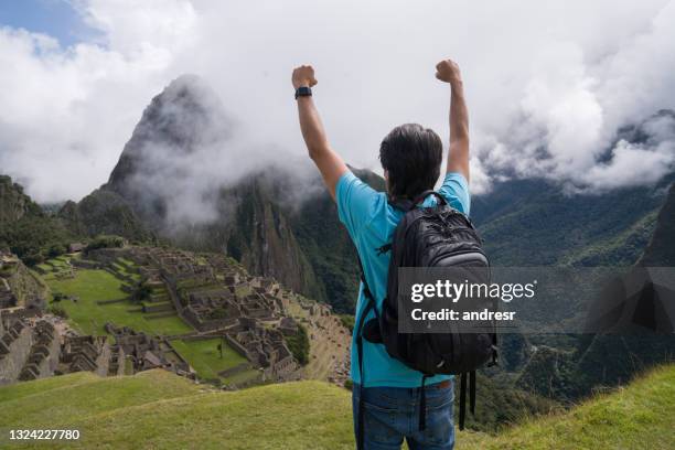 man in machu picchu celebrating reaching the top of a mountain - urubamba valley stock pictures, royalty-free photos & images