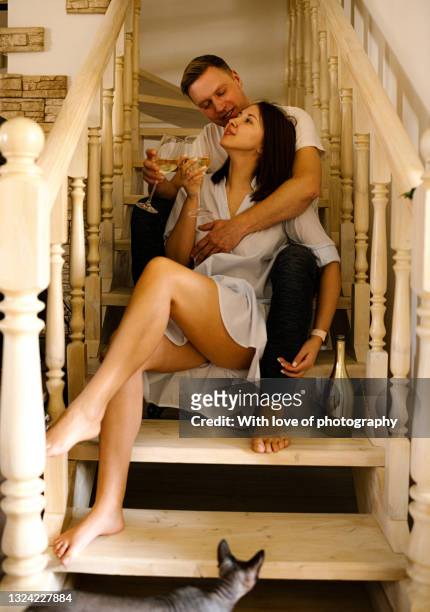 young adult european heterosexual couple at new home just married, 30-35 years - 25 29 years foto e immagini stock