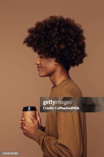 emotional african american man with african hairstyle holding coffee - guy with afro stock pictures, royalty-free photos & images