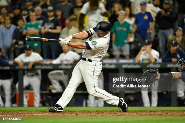 Kyle Seager of the Seattle Mariners hits a walk-off single RBI to win the game against the Tampa Bay Rays at T-Mobile Park on June 17, 2021 in...