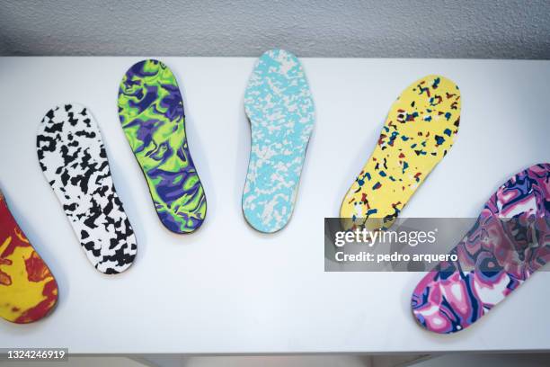 orthopedic insoles of various colors - foot arch stock-fotos und bilder