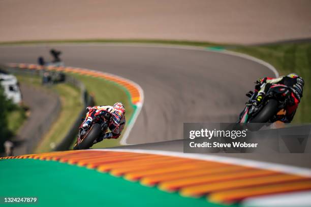 Marc Marquez of Spain and Repsol Honda Team rides in front of Aleix Espargaro of Spain and Aprilia Racing Team Gresini during the MotoGP Liqui Moly...