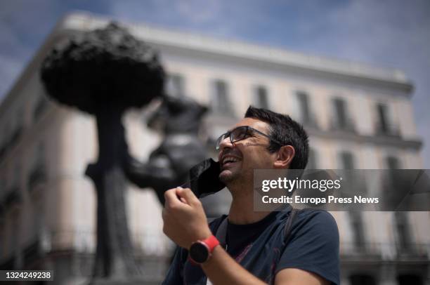 Man removes his mask in Puerta del Sol on June 18, 2021 in Madrid, Spain. The President of the Government, Pedro Sanchez, has announced that masks...