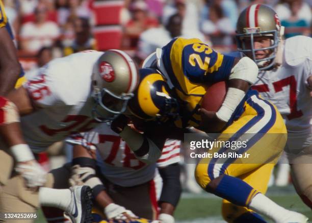 Los Angeles Rams Eric Dickerson makes helmet-to-helmet contact during game action against San Francisco 49'ers , October 27, 1985 in Anaheim,...