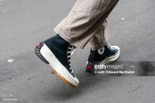 Guest wears beige pants, black JW Anderson X Converse All Star sneakers, outside Berluti, during Paris Fashion Week - Menswear F/W 2020-2021 on...