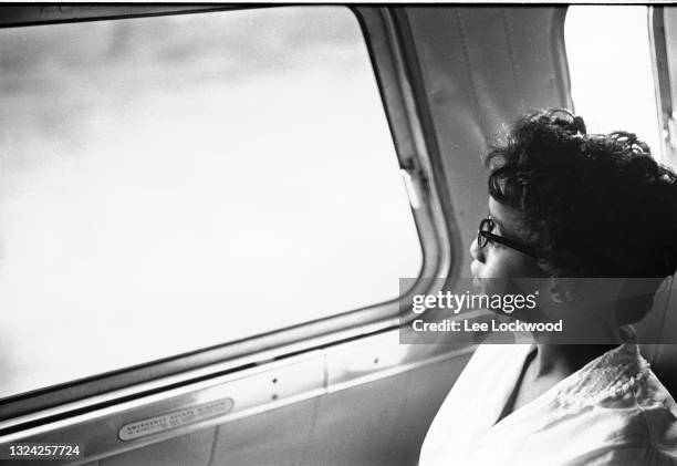 Profile of an unidentified Freedom Rider as she looks out of a bus window, late May 1961. The photo was taken during the Montgomery, Alabama to...