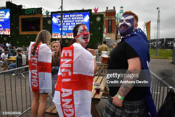 An England supporter reacts to the camera after kissing a Scotland supporter at the 4TheFans Fan Park at Event City in Manchester on June 18, 2021 in...