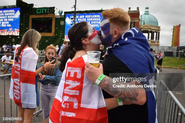 An England supporter kisses a Scotland supporter at the 4TheFans Fan Park at Event City in Manchester on June 18, 2021 in Manchester, England....