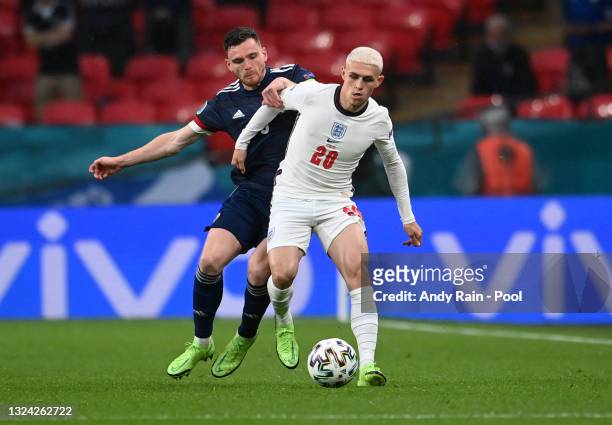 Phil Foden of England is challenged by Andrew Robertson of Scotland during the UEFA Euro 2020 Championship Group D match between England and Scotland...