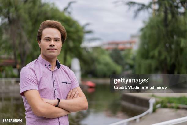 portrait of a confident gay man looking at camera - non binary stereotypes stock pictures, royalty-free photos & images