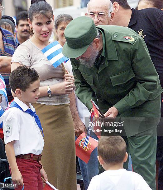 Cuban leader Fidel Castro talks with Elian Gonzalez July 10, 2001 at the closing ceremony of a meeting of the island''s Communist group for...