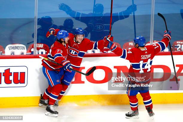 Cole Caufield of the Montreal Canadiens is congratulated by Tyler Toffoli and Nick Suzuki after scoring a goal against the Vegas Golden Knights...