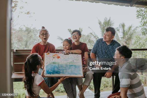 little cute art product of granddaughter shows to family-stock photo - drawing artistic product 個照片及圖片檔