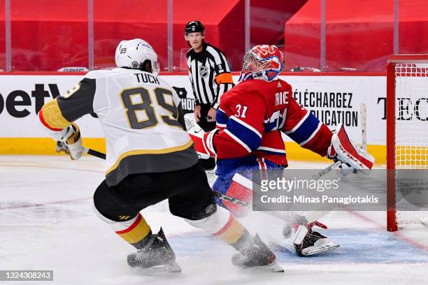 Carey Price of the Montreal Canadiens makes the save against Alex Tuch of the Vegas Golden Knights during the third period in Game Three of the...