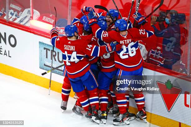 Josh Anderson of the Montreal Canadiens is congratulated by his teammates after scoring the game-winning goal against the Vegas Golden Knights during...