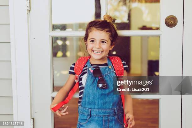 cute little girl wearing backpack headed to her very first day of school - first day of school bildbanksfoton och bilder