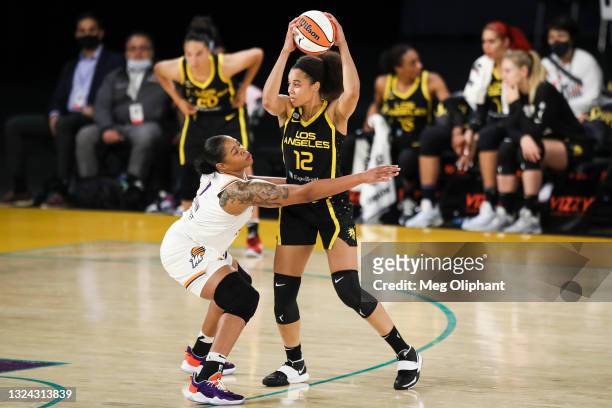 Forward Nia Coffey of the Los Angeles Sparks handles the ball defended by center Kia Vaughn of the Phoenix Mercury at Los Angeles Convention Center...