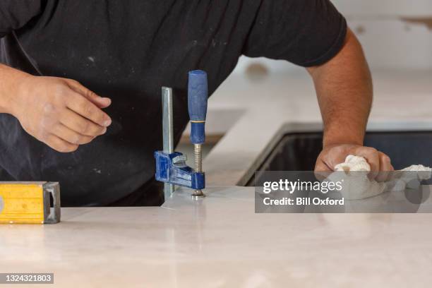 installing kitchen countertops in home remodel - quartz stock pictures, royalty-free photos & images