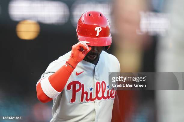 Andrew McCutchen of the Philadelphia Phillies tips his helmet as he crosses home plate after hitting a home run against the San Francisco Giants...