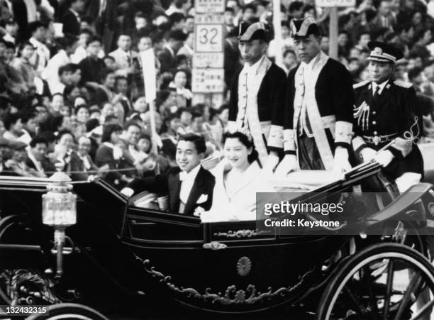 Crown Prince of Japan, Akihito and Michiko Shoda driving through Tokyo after their wedding at Tokyo Imperial Palace, 10th April 1959.