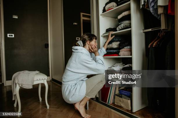 aufwachen und einen moment der planung eines tages haben - kleiderschrank frau stock-fotos und bilder