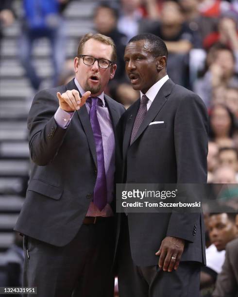 Assistant coach Nick Nurse of the Toronto Raptors talks to head coach Dwane Casey against the Boston Celtics during NBA game action at Air Canada...
