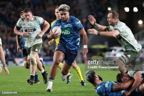 Hoskins Sotutu of the Blue is tackled by Hugh Renton of the Highlanders during the Super Rugby Trans-Tasman Final match between the Blues and the...