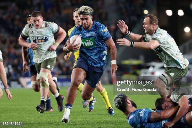 Hoskins Sotutu of the Blue is tackled by Hugh Renton of the Highlanders during the Super Rugby Trans-Tasman Final match between the Blues and the...