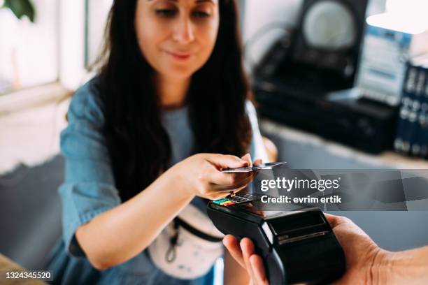 woman making contactless payment with credit card - card payment bildbanksfoton och bilder