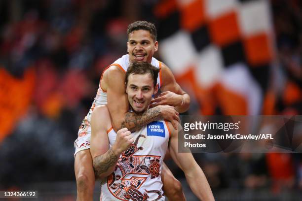 Jeremy Finlayson of the Giants celebrates kicking a goal with Bobby Hill of the Giants during the round 14 AFL match between the Greater Western...
