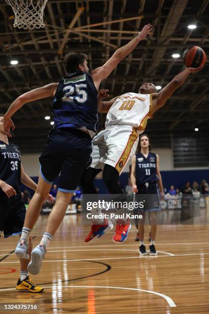 Scott Machado of the Magic drives to the basket against Michael Vigor of the Tigers during the NBL1 West match between Willetton Tigers and Mandurah...
