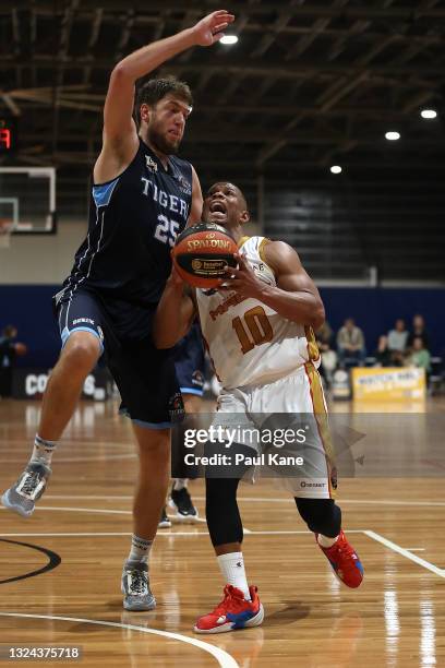 Scott Machado of the Magic drives to the basket against Michael Vigor of the Tigers during the NBL1 West match between Willetton Tigers and Mandurah...