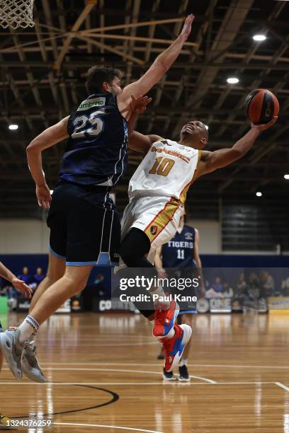 Scott Machado of the Magic drives to the basket against Michael Vigor of the Tigers during the NBL1 West match between Willetton Tigers and Mandurah...