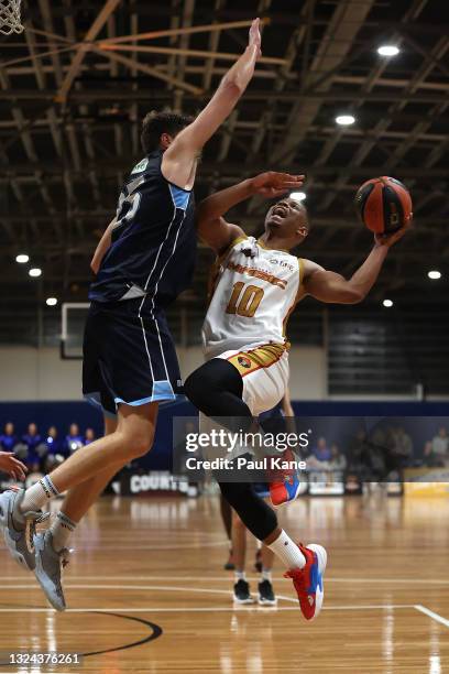 Scott Machado of the Magic drives to the basket against Michael Vigor of the Tigers during the NBL1 West match between Willetton Tigers and Mandurah...