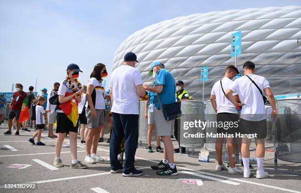 Fans of Germany are directed by members of match day staff at the ticket check point prior to the UEFA Euro 2020 Championship Group F match between...