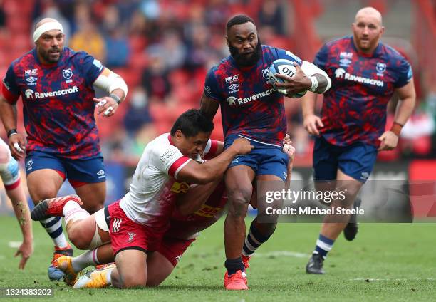 Semi Radradra of Bristol Bears is tackled by Ben Tapuai and Wilco Louw of Harlequins during the Gallagher Premiership Rugby semi final match between...