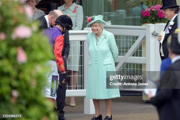 Queen Elizabeth II watches as horses are led into the parade ring during Royal Ascot 2021 at Ascot Racecourse on June 19, 2021 in Ascot, England.